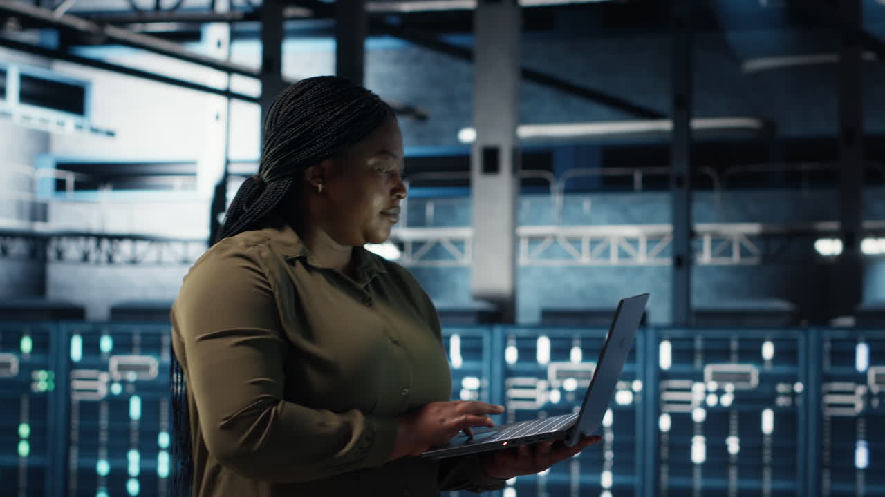 Admin in data center using app on laptop to ensure error free rigs networks