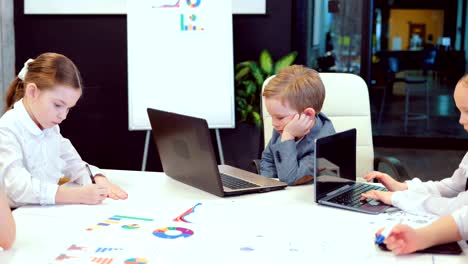 team of seven business children in office clothes meeting in a modern office