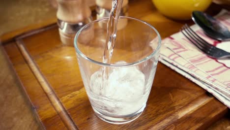 Mineral-water-pouring-into-a-glass,-the-morning-Breakfast,-Slow-motion-with-rotation-tracking-shot.