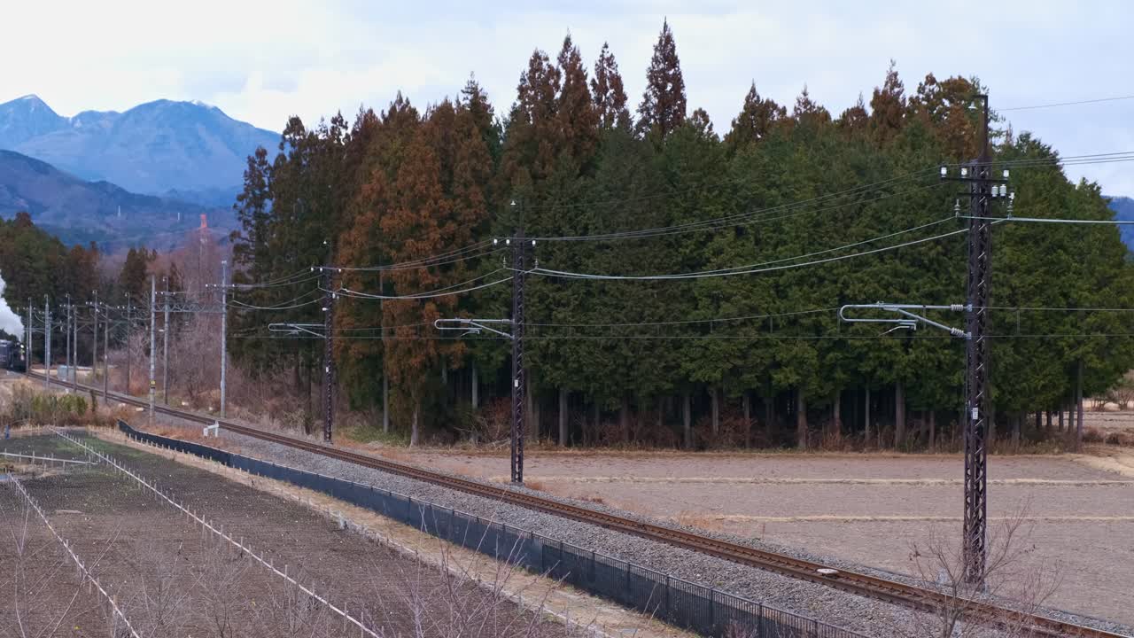 Steam Locomotive Running And Releasing Steam in Japan Countryside, Wide Shot