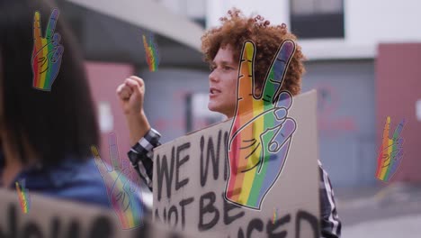 animation of rainbow hand over mixed race male protester with banner