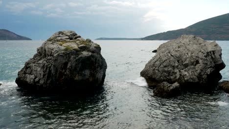 waves beating on the rocks on the beach in montenegro