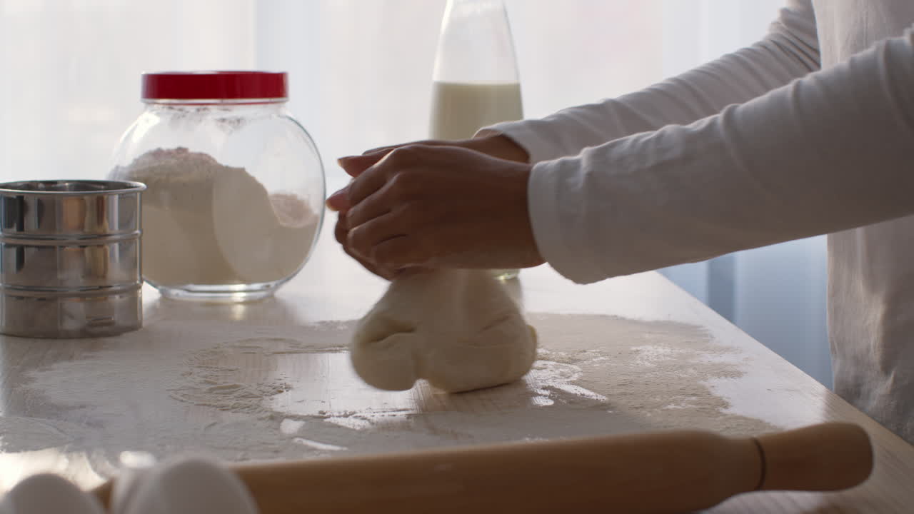 Woman Kneading Dough in Kitchen