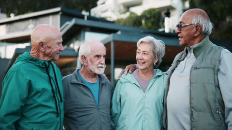 group of senior friends enjoying a conversation outdoors