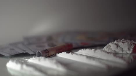 Several-lines-of-white-powder-drugs-on-mirror-rack-focus-isolated-scene-with-police-lights-flashing