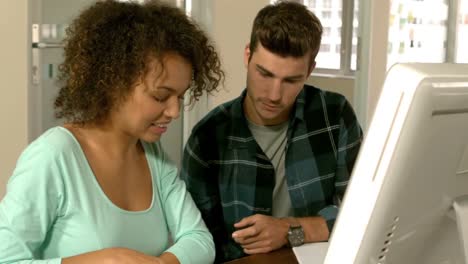 happy creative team looking at a monitor