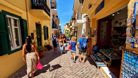 a sunny day walking through a narrow street in a greek town