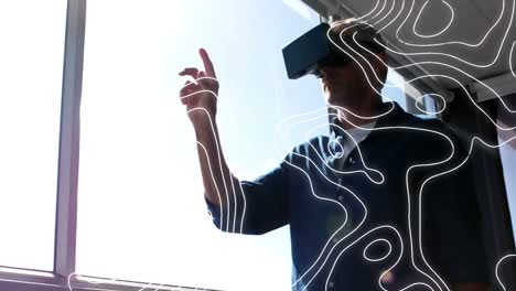 animation of moving topographic chart, over man in vr headset gesturing on virtual interface