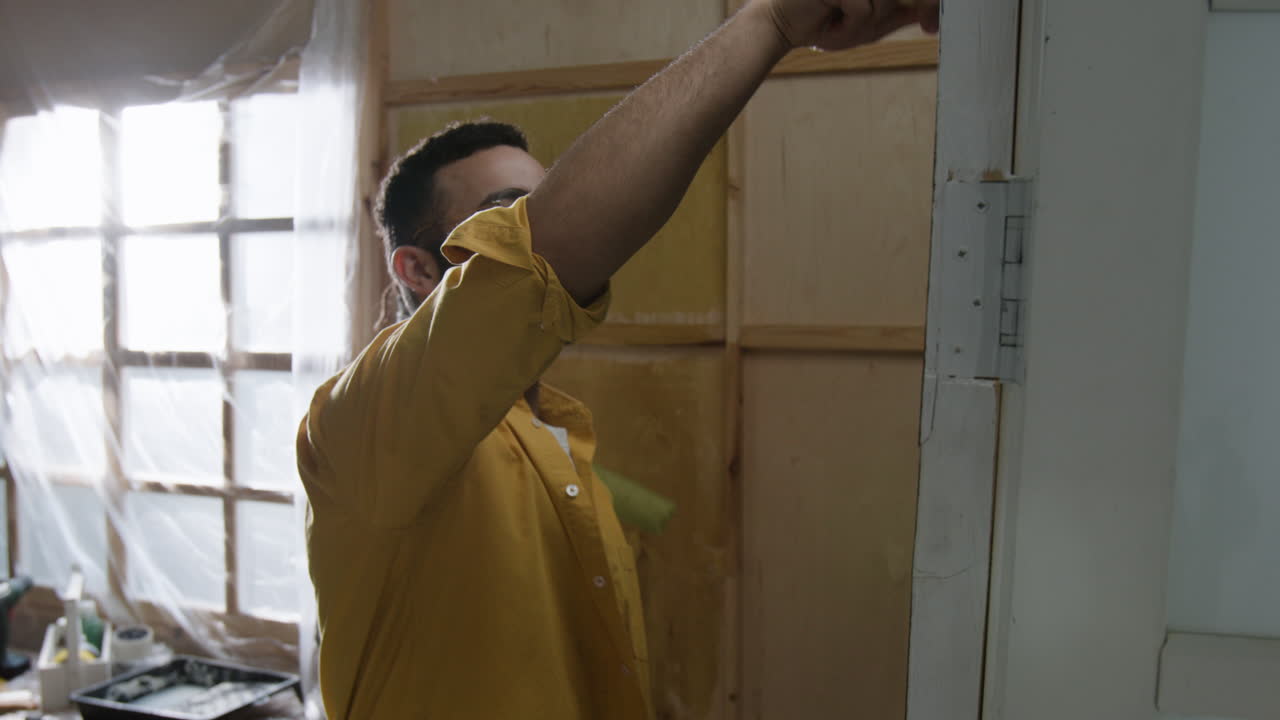 Man Repairing Door Frame During Home Renovation