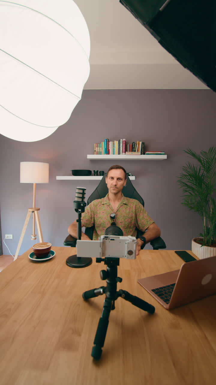 Man vlogging or podcasting from home studio