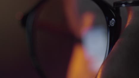 person looking at a facebook post reflected in glasses