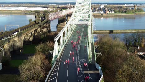 charity santa dash fun run over runcorn silver jubilee bridge aerial view locked off