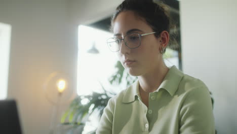 girl typing on laptop at desk