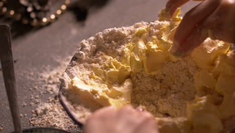 close up, child's hands putting butter into baking mix in bowl in kitchen