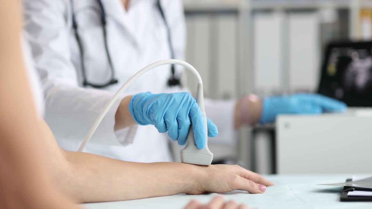 Doctor Performing Ultrasound Examination on Patient's Hand