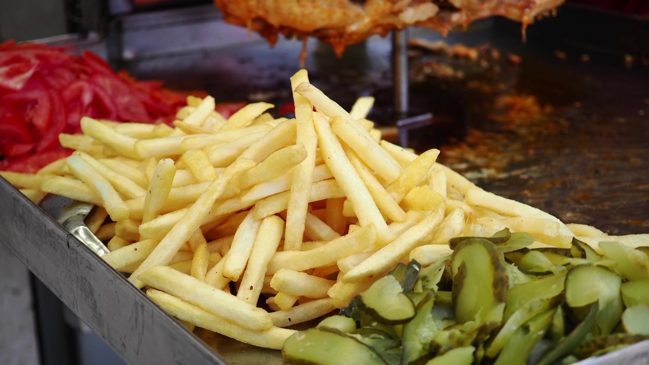 Fresh French Fries Served with Sliced Tomatoes and Pickles