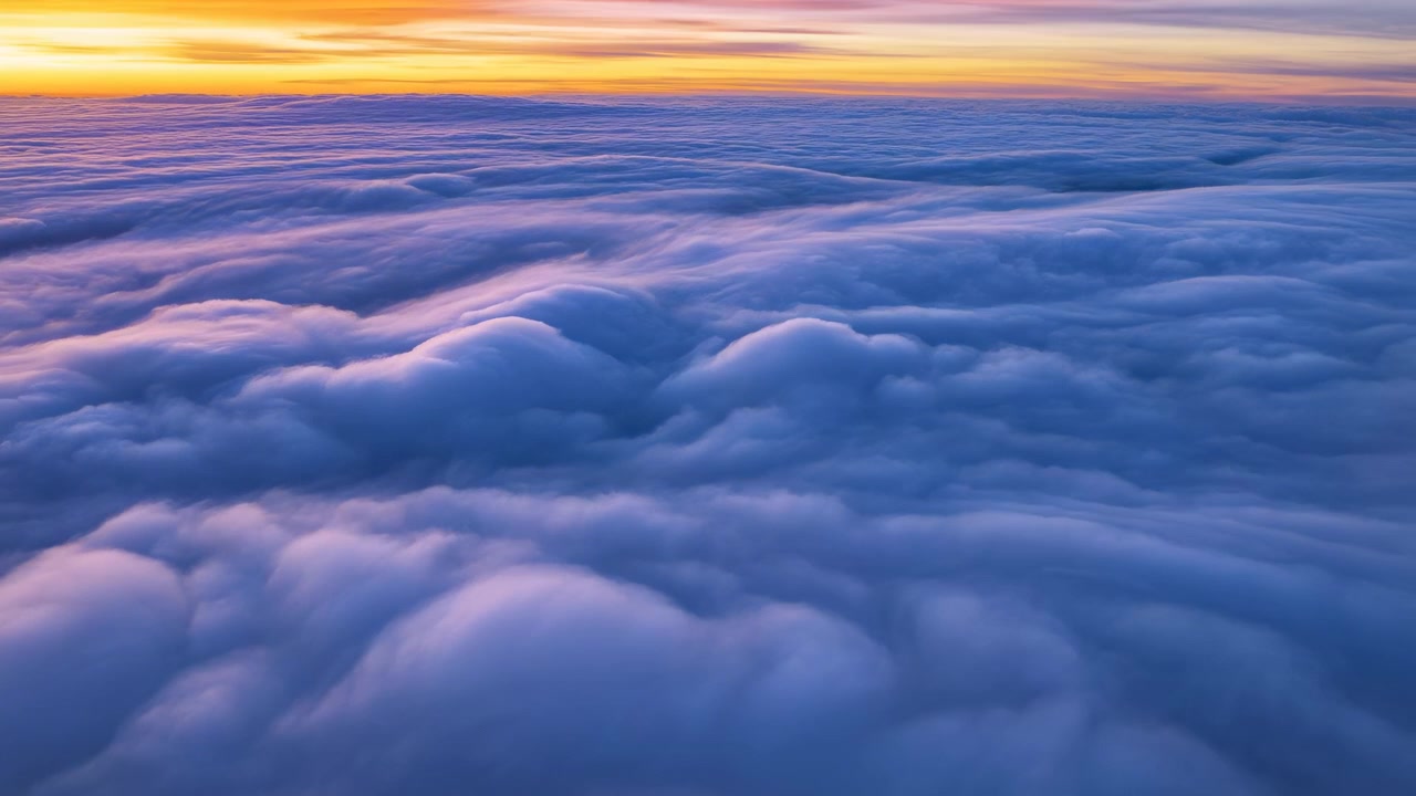 Cloudscape sunset over clouds, in sky, with clouds, sun, with air texture, from a aerial perspective perspective, with yellow, orange accents, and serene and tranquil mood, clear detail.