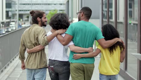 Back-view-of-friends-walking-on-street