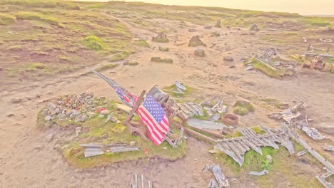 aerial orbit over memorial stone grave at the b-29 superfortress wwii plane crash site in the peak district, england. american flag waving in the wind over historic site.
