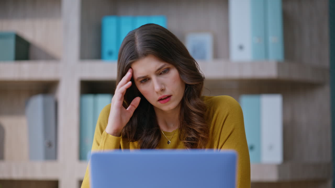 Disappointed employee reading email on laptop sitting company workplace closeup