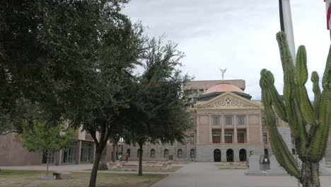 Arizona-state-capitol-building-in-Phoenix,-Arizona-with-closeup-showing-trees-and-panning-left-to-right