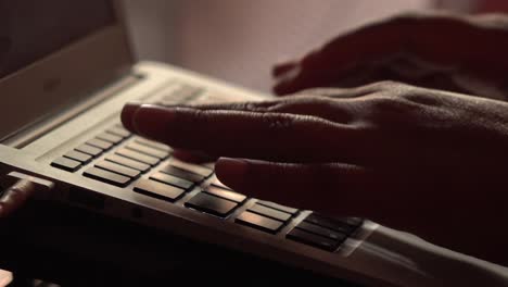 close up of hands typing on a computer