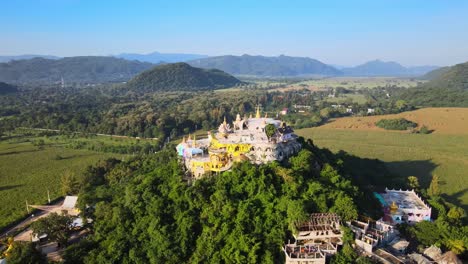 panning left to right around strange temple on a mountain in thailand, asia