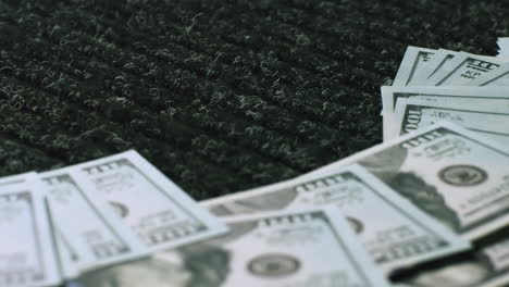 us dollars on a dark carpet