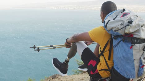 sporty mixed race man with prosthetic leg enjoy his hike