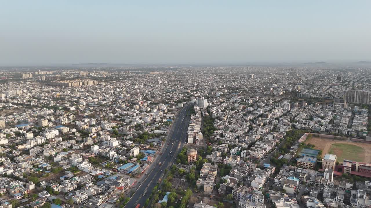 High-angle view of busy Jaipur streets, capturing the chaotic yet vibrant flow of auto rickshaws, bikes, and cars