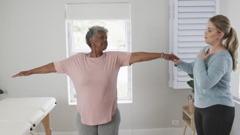 Caucasian-nurse-with-senior-woman-exercising,-copy-space,-slow-motion