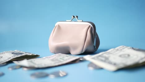 light beige wallet with money and coins