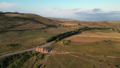 Golden-hour-aerial-orbits-Bells-of-Goris-Monument-in-southern-Armenia