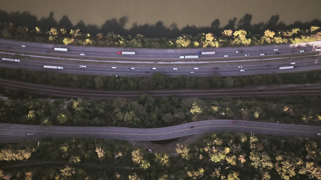 Top-down aerial view of highways and railways running parallel to the Tennessee River, surrounded by green forested areas