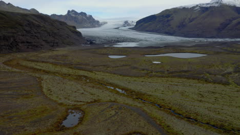 Aerial:-Panoramic-view-of-beautiful-glacier-landscape-in-Iceland-during-overcast-day