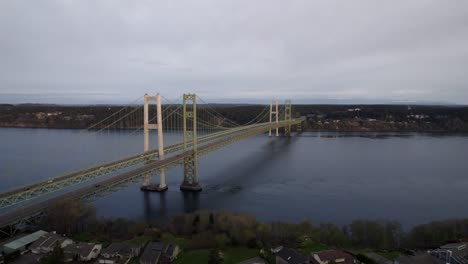 light traffic flowing along the tacoma narrows bridge, dull cloudy skies, aerial wide angle