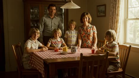 a warm family gathering: capturing a cherished moment around the dining table, featuring parents with their children enjoying time together in a cozy setting