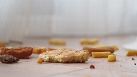 crumbs and fries on the floor