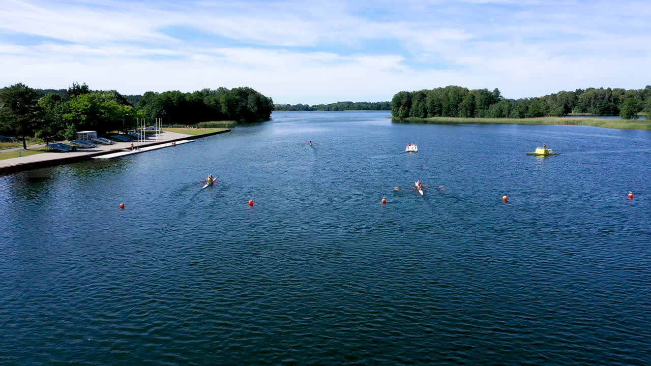 LUFTFOTO: Efterfølgende optagelse af kajakatleter i kanoer på søens overflade, der ræser fremad