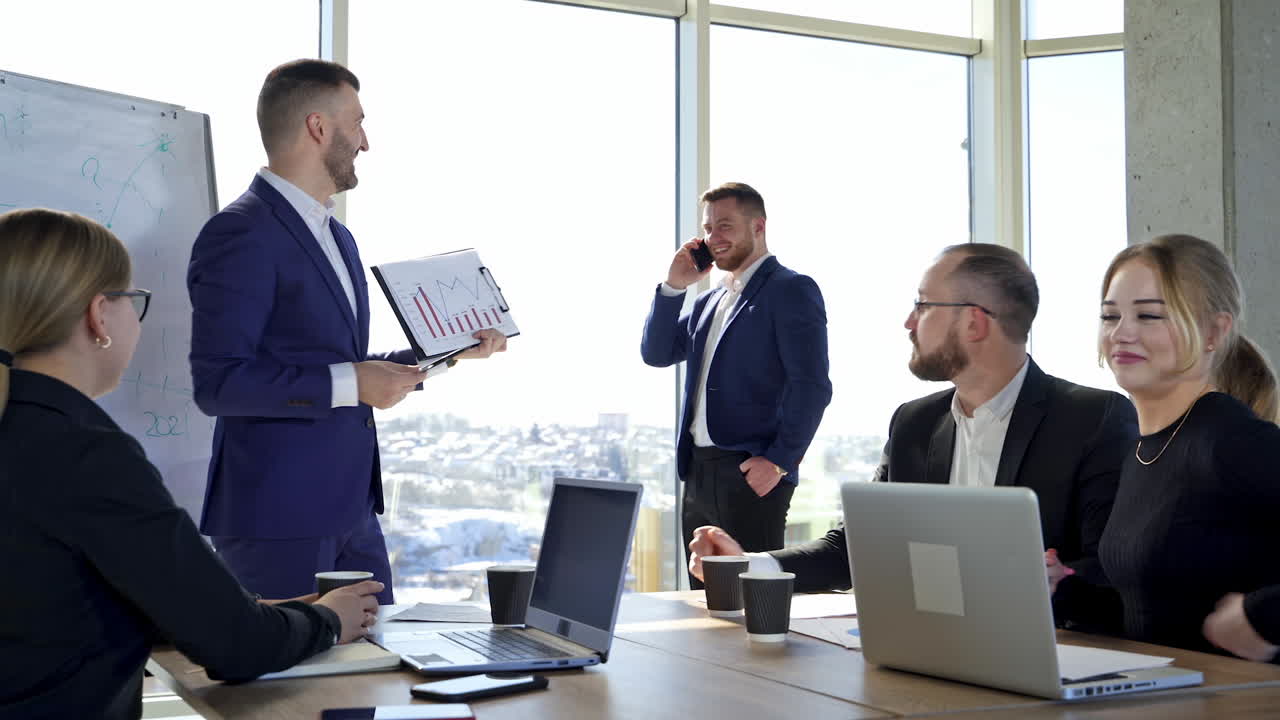 Positive business people in office. Team of entrepreneurs collaborating together. Man leader explaining business strategy to his colleagues.