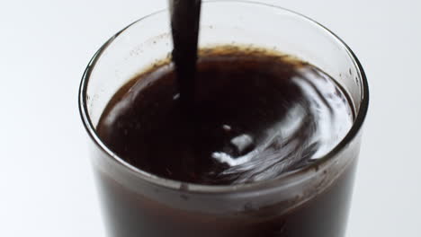 brew black coffee in a glass with a spoon