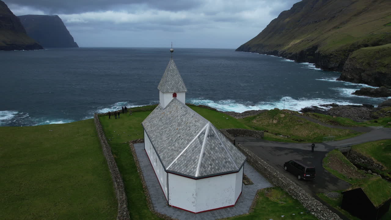 Vi&eth;arei&eth;i church, Faroe Islands: aerial view traveling out from the back of the church and where you can see the ocean