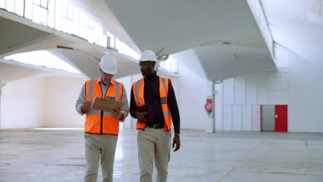 two engineers inspecting warehouse construction