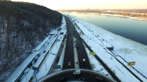 cars on road junction in winter city. aerial view car traffic on winter highway
