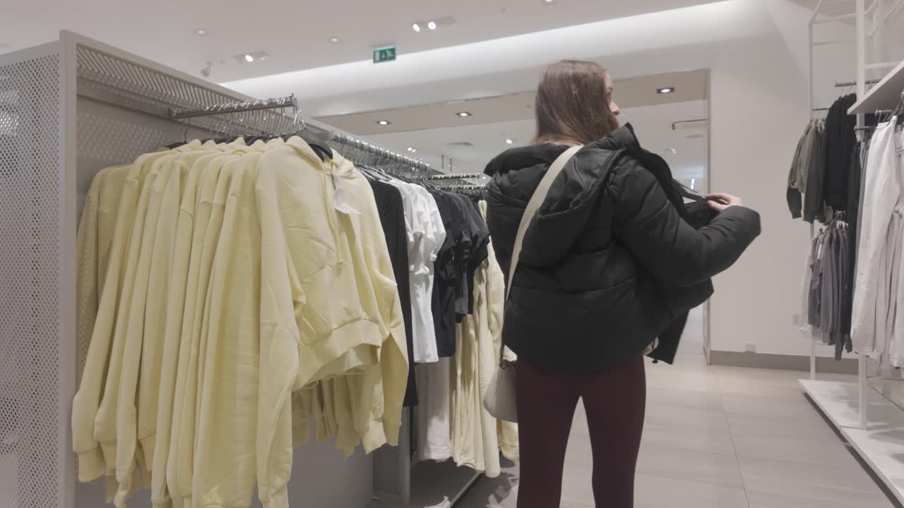 Fashion department store, female customer blouse choices, denim jeans