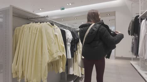 fashion department store, female customer blouse choices, denim jeans