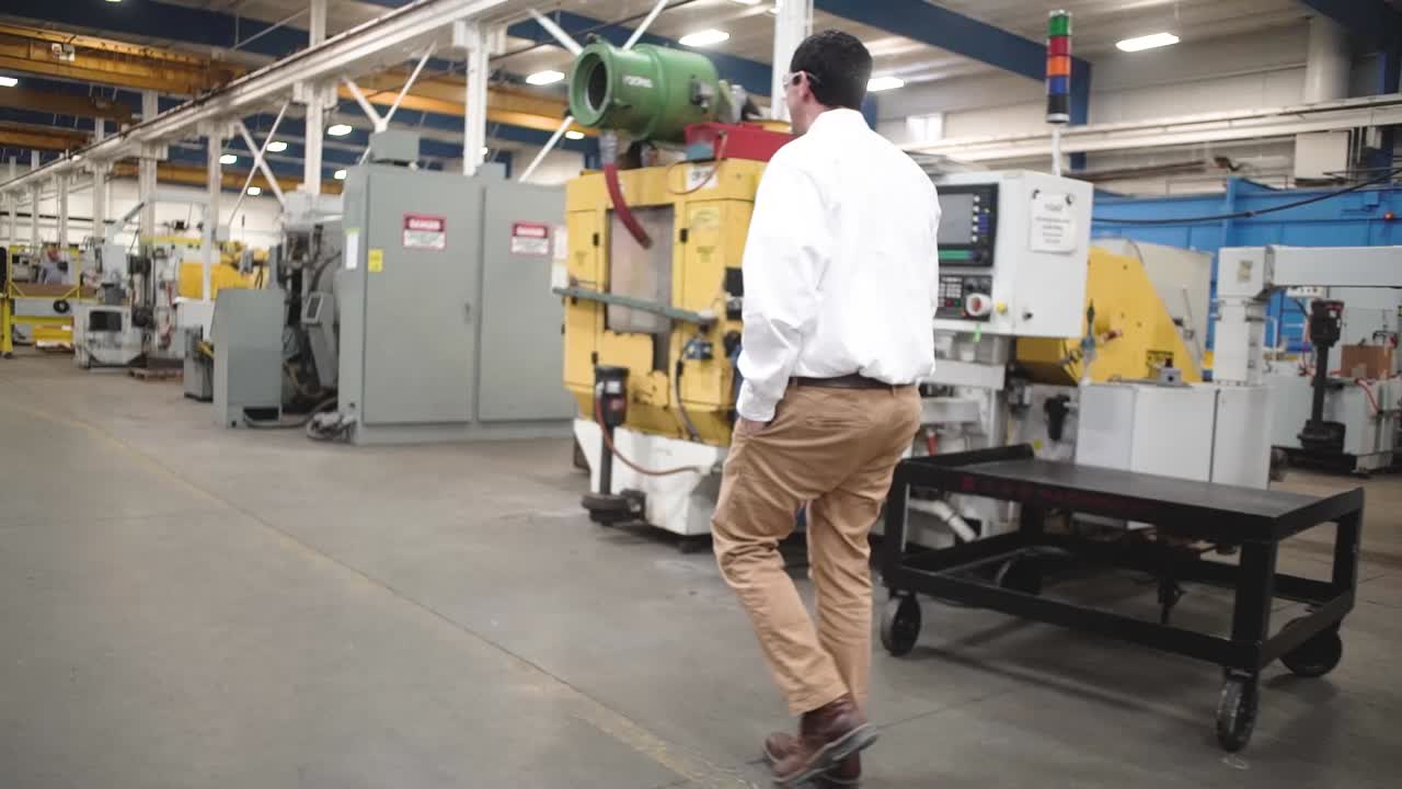 Side view of an Engineer walking into a manufacturing plant in Howell, Michigan