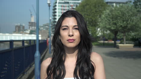 Portrait-of-a-beautiful-hispanic-latina-young-woman-looking-at-the-camera-and-show-emotions-from-serious-to-smiling-and-laughing