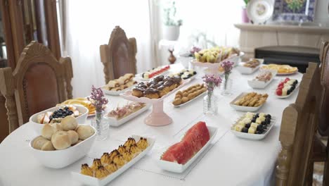 elegant dining table with a variety of appetizers and desserts arranged beautifully, ready for a celebration or gathering