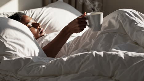 woman enjoying coffee in bed